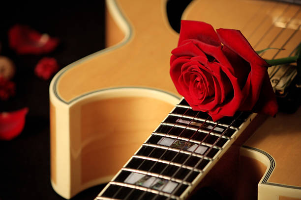 istock Beautiful red rose on jazz guitar 91770345