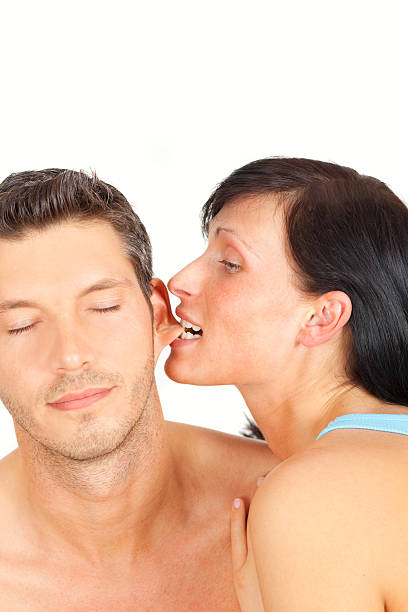 ear biting woman stock photo