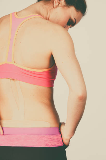 istock Woman with medical kinesio taping on back 917714930