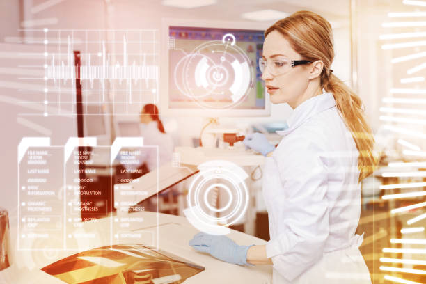 istock Clever young doctor sitting at the microscope and looking busy 917715170