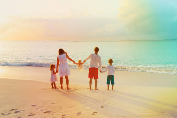 istock happy family with kids walk on sunset beach 917716966