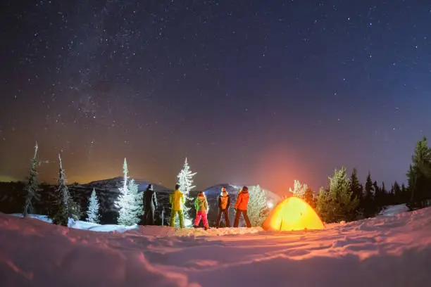 Photo of Travel night camping winter concept with friends and tent