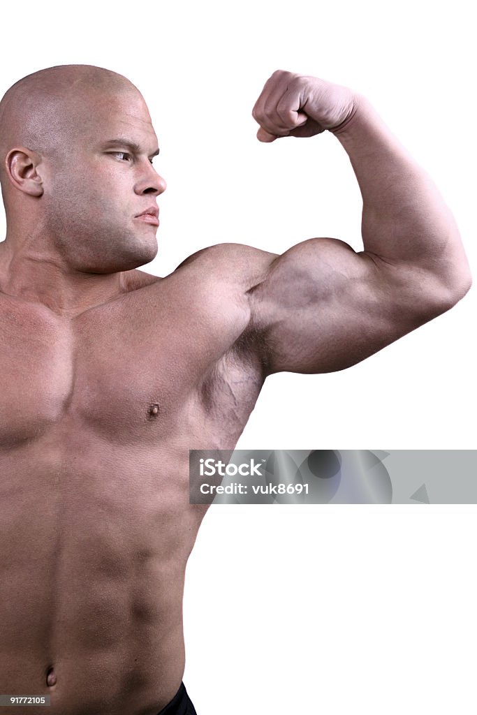 Człowiek Napinać biceps, aby pokazać swoją wytrzymałość - Zbiór zdjęć royalty-free (Bez koszulki)