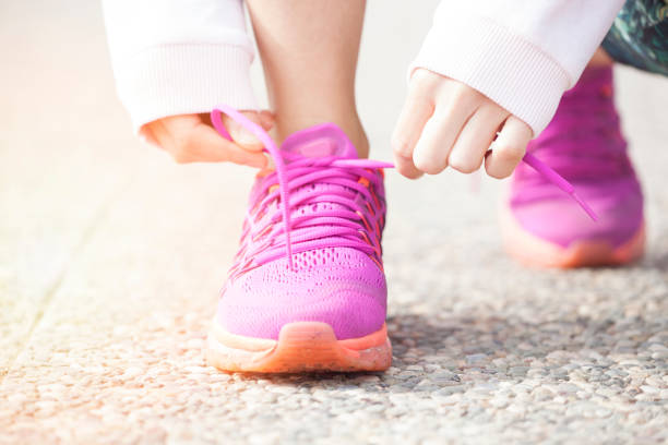 istock Young woman runner tying shoelaces 917723274