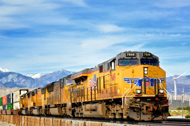 Palm Springs, California, USA - January 14, 2018: A Union Pacific Railroad locomotive pulling a freight train with overseas container carriers near Palm Springs, Coachella Valley, Western USA.