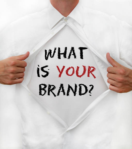 Man opens shirt to reveal: "What is YOUR brand?" stock photo