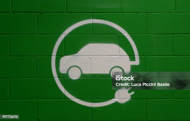 Electric Vehicle Parking Only Sign On Green Brick Wall Background Stock Photo - Download Image Now