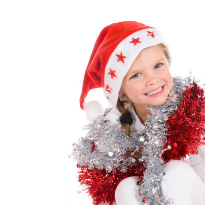 cute little girl wrapped in christmas decoration with on the left copy-space.