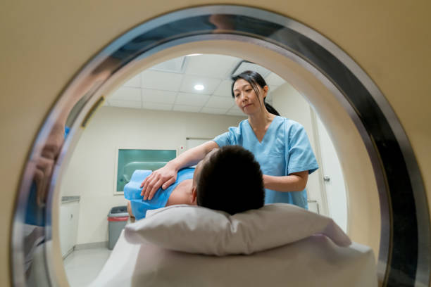 istock Asian radiologist getting a patient ready for an MRI 917730182