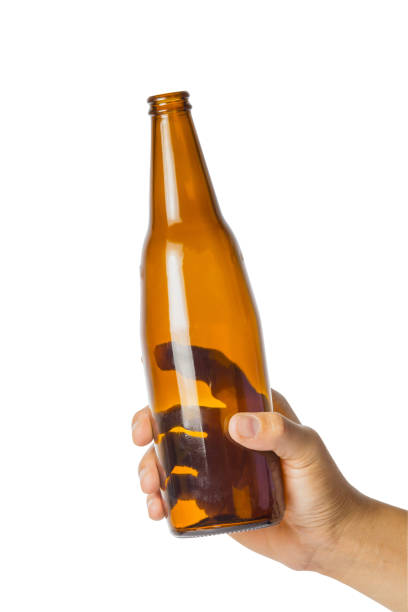istock Woman's hand holding empty beer bottle transparent on white background 917730388