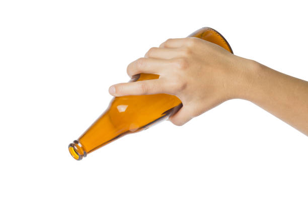 istock Woman's hand holding empty beer bottle transparent on white background, 917730396