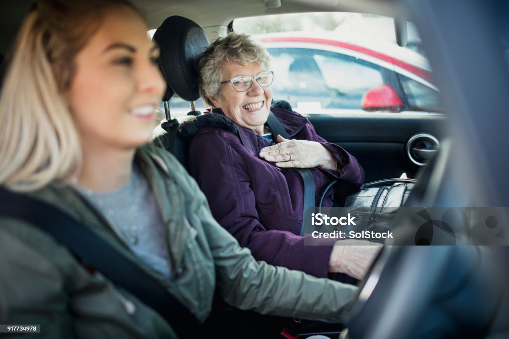 In the Car with Grandma Young woman and her Grandmother sitting in a car. Senior Adult Stock Photo