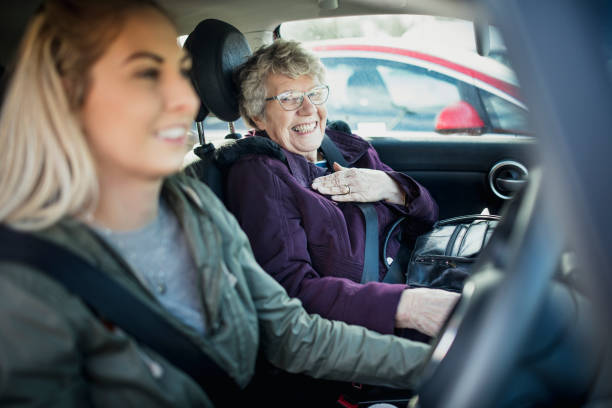 In the Car with Grandma Young woman and her Grandmother sitting in a car. day in the life stock pictures, royalty-free photos & images