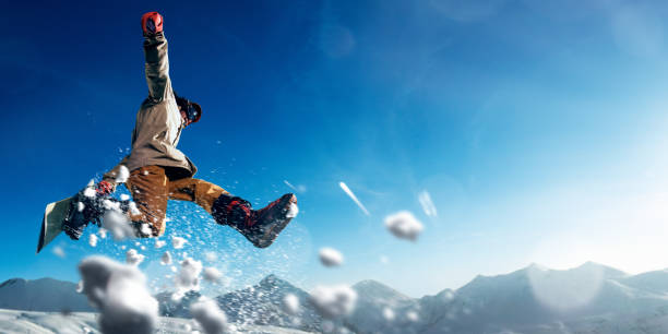 Austria is famous for its ski slopes. During winter this country turns into a winter wonderland full of joy and happiness. A couple jumping into the snow out of happiness.