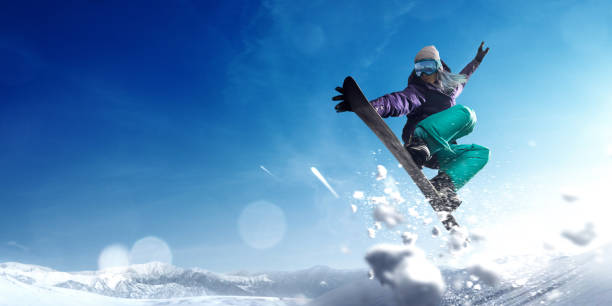 Witness the snowboarder wallride wonders, executing impressive tricks with poise and precision, enhancing the slope experience.