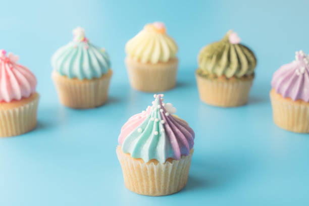 istock Rainbows cupcake muffin on blue pastel background 917739378
