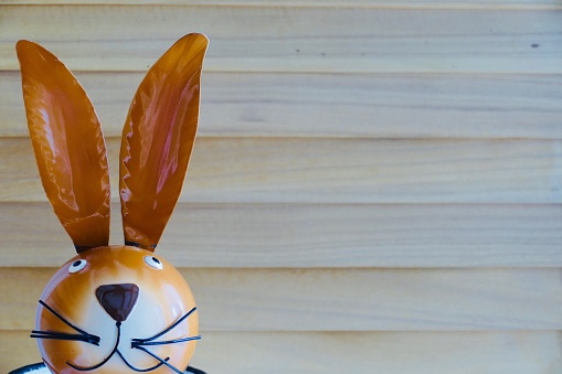 Easter rabbit head on wooden background