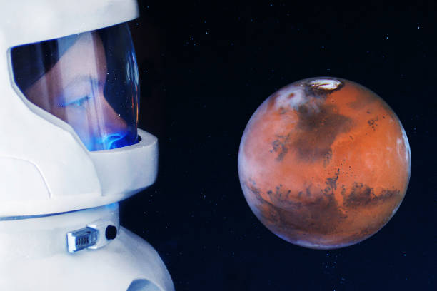 istock Development of Mars, concept. Astronaut, looking at the planet Mars. Elements of this image furnished by NASA. 917742970