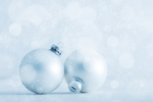 Christmas glass balls on cold frosty glitter background. Christmas greeting card