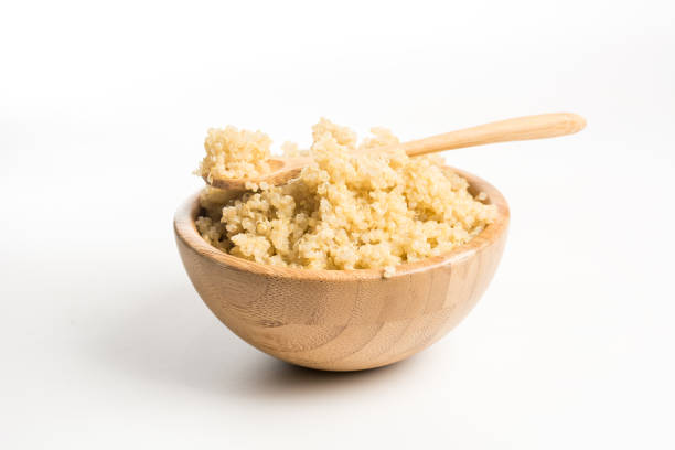 Wooden Bowl full of quinoa. stock photo