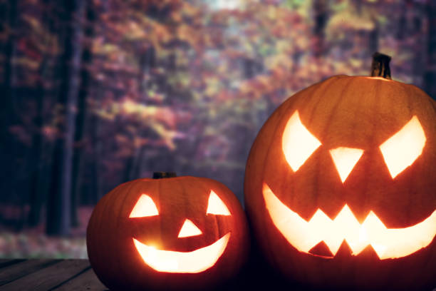 istock Halloween pumpkins on autumn forest background 917744080