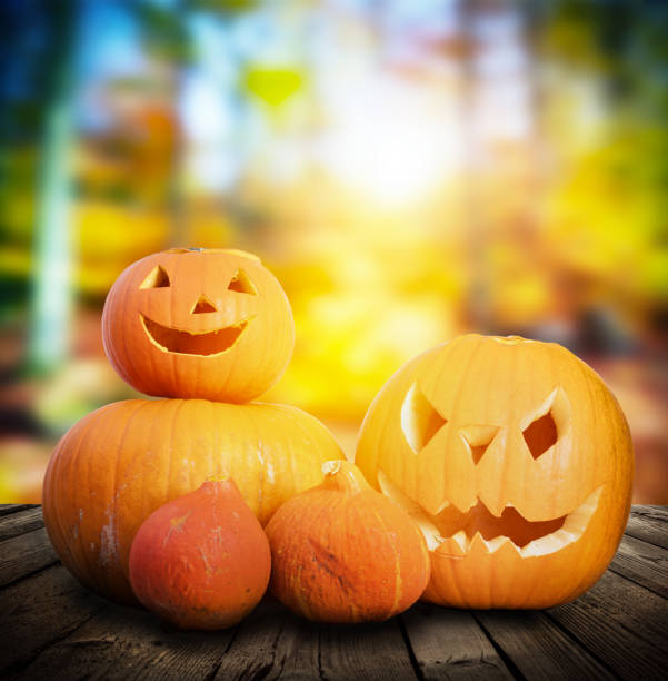 istock Halloween pumpkins on autumn forest background 917744172