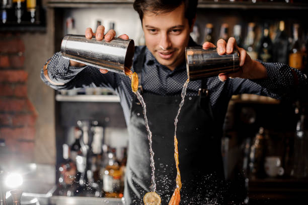 istock Bartender making a cocktail with slices of fresh orange fruit 917744560