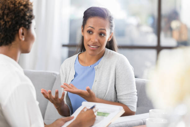 istock Woman gestures while talking with mental health professional 917744790