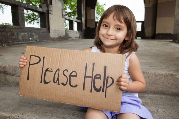 prepubescent boy asking for help, dressed in red, with a slate and a white background