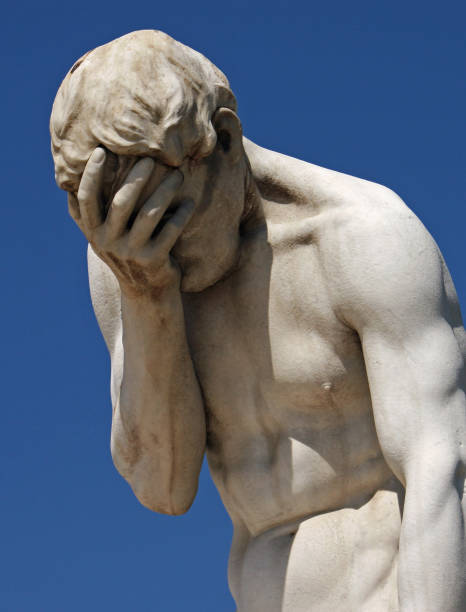 Facepalm statue holding head in hand