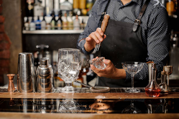 istock Barman crushing a big ice cube for making a cocktail 917750608