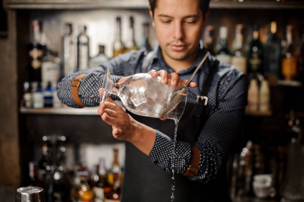 istock Young bartender pouring cold alcoholic drink from a large glass 917753920