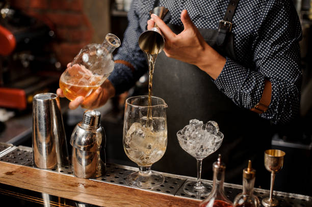 istock Bartender adding a portion of syrup into the large cocktail glass 917754554