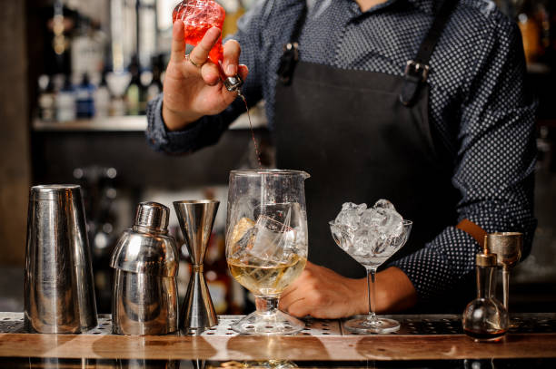 istock Bartender pouring fruit syrup into the large cocktail glass 917754776