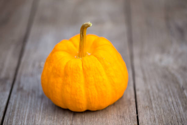 istock Yellow pumpkin on wooden table background 917758376