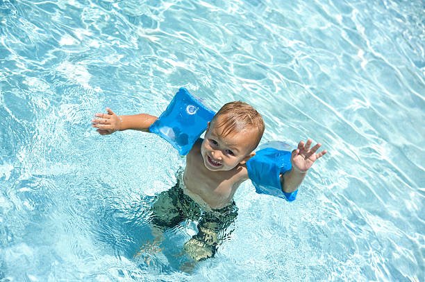 Boy in the swimming pool stock photo