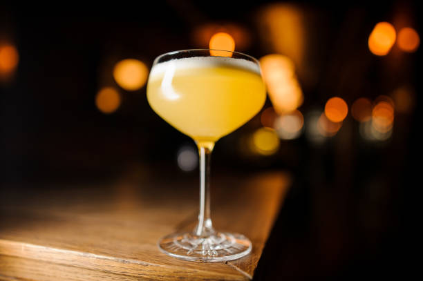 istock orange cocktail on blurred background with lights 917758974