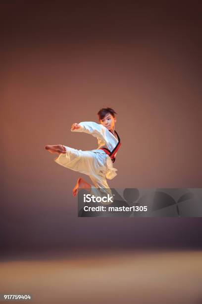 Young Boy Training Karate On Blue Background Stock Photo - Download Image Now - Child, Karate, Judo