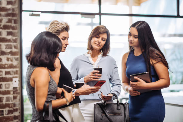 istock Group of businesswomen checking new mobile app 917762666