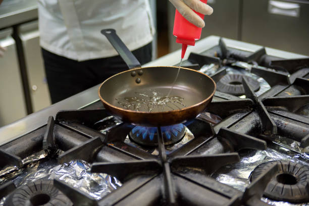 istock Pouring vegetable oil into frying pan 917763390
