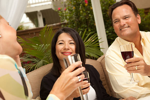 istock Three Friends Enjoying Wine on the Patio 91776493