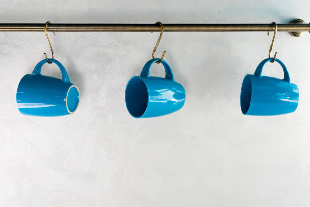 close-up view of empty blue cups hanging in kitchen