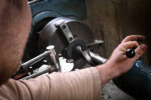 istock Metal worker shaping metal on lathe machine 917774238