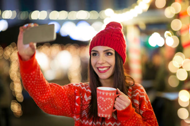 istock Women using smartphone at Christmas market 917777584
