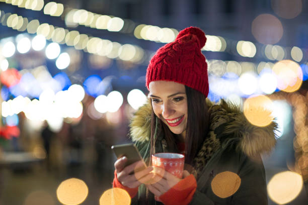 istock Women using smartphone at Christmas market 917777592