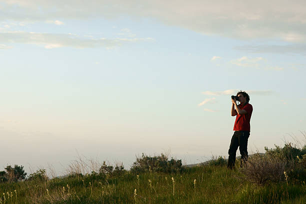 Man Photographing Sunset Hill stock photo