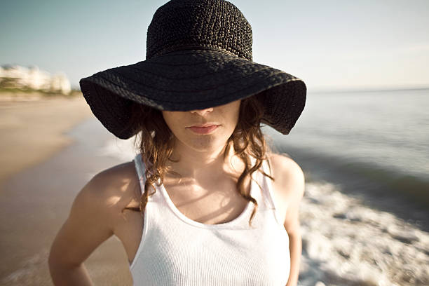 Floppy hat at the beach stock photo