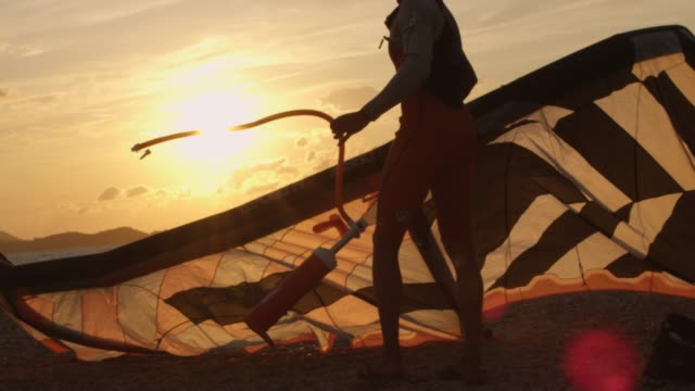 SLO MO Kitesurfer setting the kite on the beach