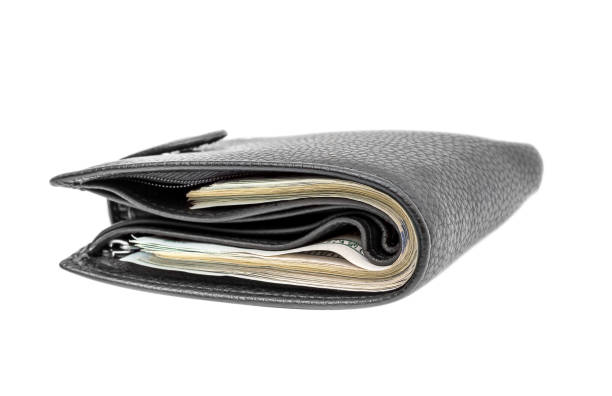 istock Closed black wallet with money isolated on white. 917798312