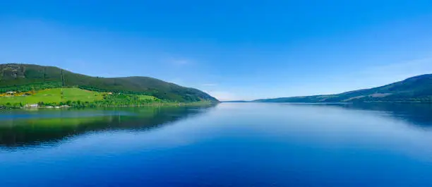 Loch Ness, a large, deep, freshwater loch in the Scottish Highlands worldwide famous for its castle, Castle Urquhart, and for its monster, the shy "Nessie".